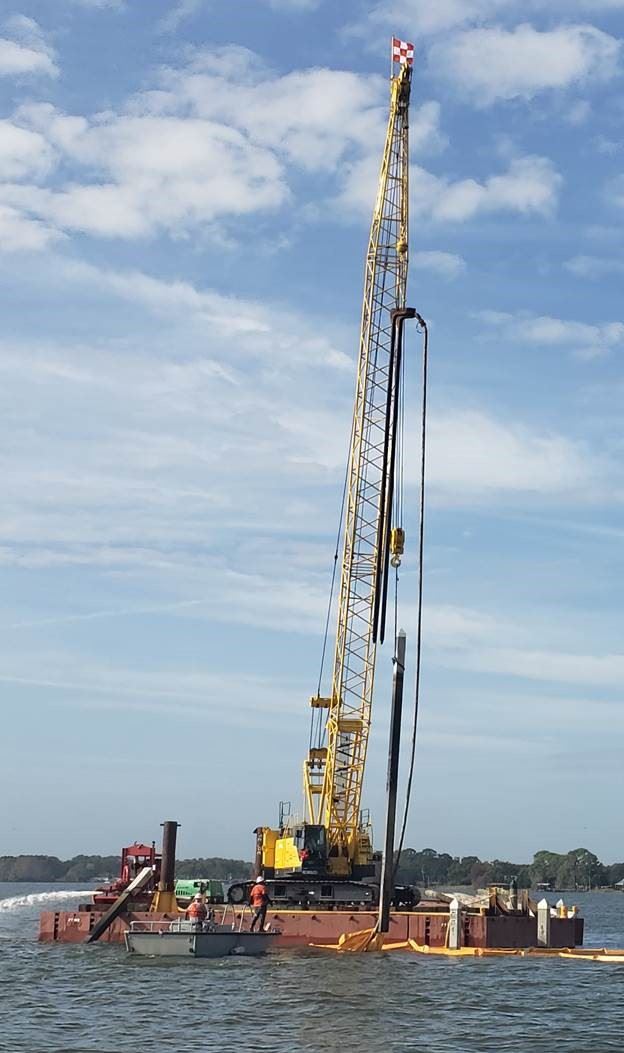 Image of Construction Crane removing old marina pilings Jan 14 2020
